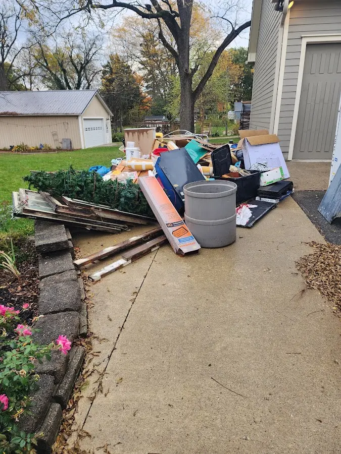 Dumpster being loaded with debris for Estate Cleanout Dumpster Rental in Bay City